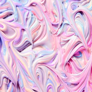 up-close photo of a soft rainbow dessert made with pastel pink, purple, and blue hues swirled together