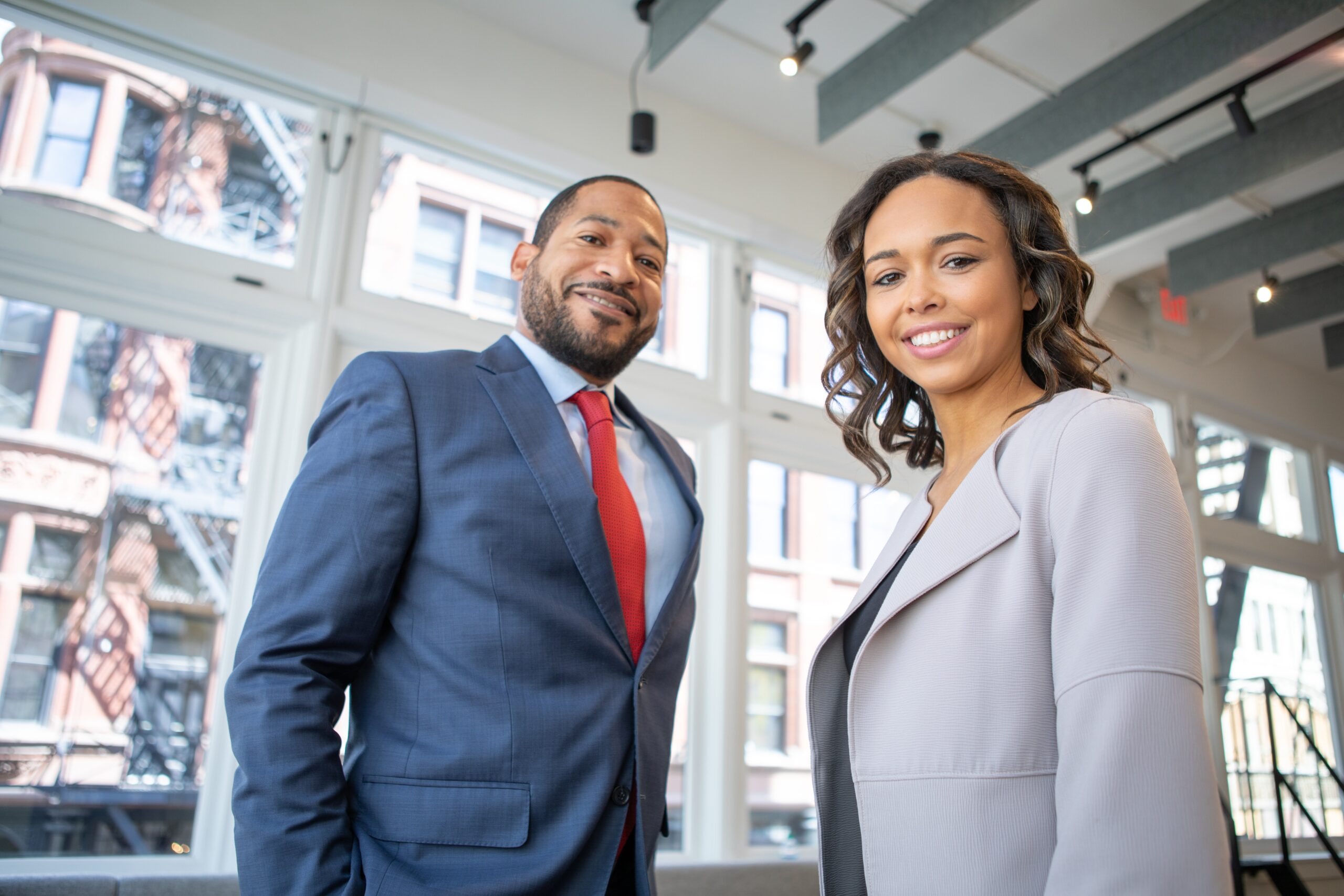 professional photo of two young business people dressed well in a business setting